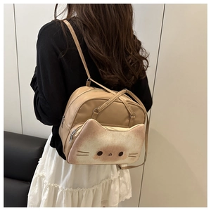 Rear view of model wearing a creative 3D cat head backpack with ears and painted face