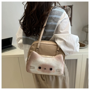 Detail of cute beige cat-shaped shoulder bag with plush 3D kitty face and embroidery