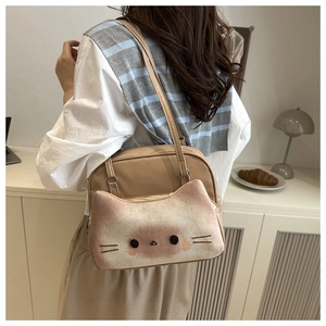 Detail of cute cat-themed beige backpack showing soft plush pocket and faux leather texture