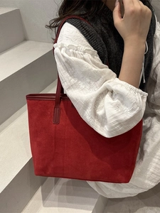 Minimalist red suede tote bag for women featuring a spacious trapezoidal design and slim straps