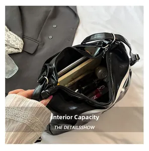 Interior view showing the large capacity of the black glossy faux leather tote bag