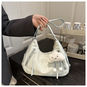 Detail of mint green ruched PU leather handbag with dual zippers and cloud charm
