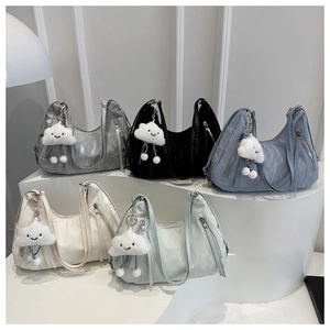 Detailed display of crescent-shaped nylon hobo bags in five colors with plush charms