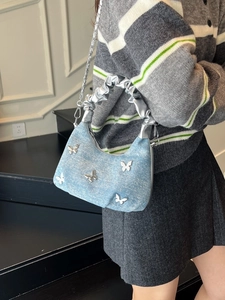 Blue denim pleated handbag with silver butterfly chain for women in Y2K vintage style