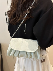 Chic mint green pleated cloud bag with metal chain strap and plush charm for women