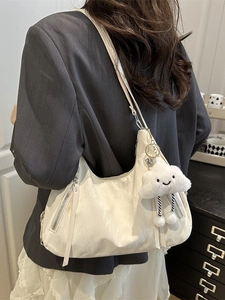 Chic beige crescent shoulder bag with soft pleated texture and cloud charm detail