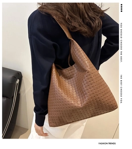 Close-up of the vintage woven texture and brown leather material on this tote bag