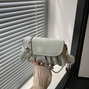 Fashionable mint green pleated crossbody bag with silver chain and plush charm pendant