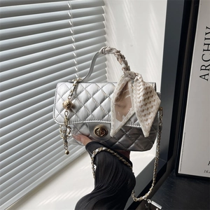Silver quilted crossbody bag with silk scarf handle and golden twist lock closure