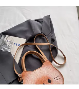 Detail showing the adjustable long strap on a vintage toasted cat shape handbag