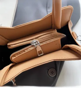 Detail of the smooth zipper pocket and dual interior compartments of the cat-themed tote bag