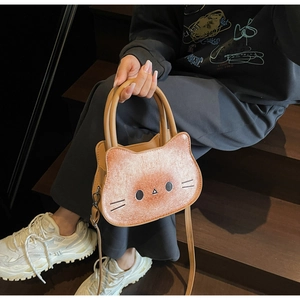 Close-up of cute cat-shaped tote bag in orange gradient with a round handle and shoulder strap