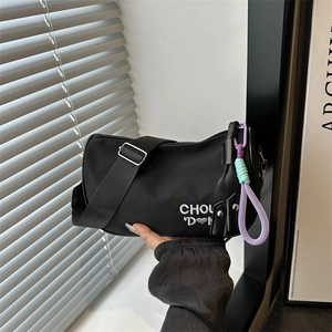 Chic black canvas crossbody bag with white heart embroidery and colorful braided strap