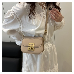 Detail view of the beige PU leather small square bag with gold metal interlocking buckle