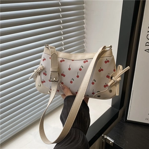 Chic cherry print baguette bag in cream PU leather with elegant ribbon details