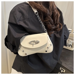 Detailed side view of white vintage underarm bag with silver star buckle and chain