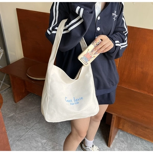 Canvas underarm bag featuring C'est lavie blue typography print for casual wear