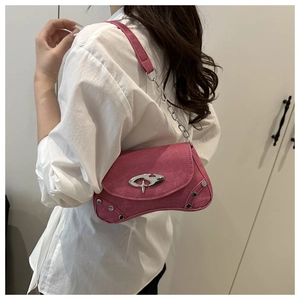 Side view of a bright pink suede shoulder bag featuring silver rivets and a metal buckle