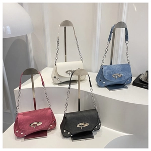 Macro detail of four mini crossbody bags in white denim pink and grey with metal buckles