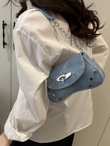 Blue textured denim-style shoulder bag with silver hardware and chain strap shown on model