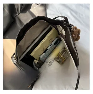 Top view showing large capacity interior of dark brown PU leather tote with bear charm