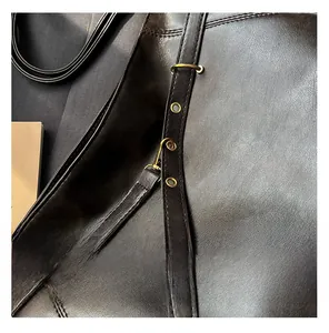 Macro view of dark brown PU leather with vintage brass eyelets and fine textured finish