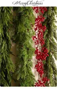 Detail of soft Norfolk pine garland with red berries and Merry Christmas signage