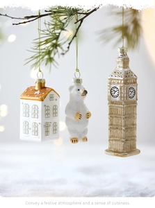 Close-up of glass Christmas ornaments including white bear and Big Ben on pine branches