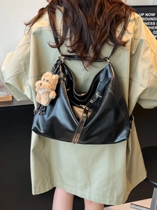 Retro black leather tote backpack with plush bear charm and adjustable strap for women