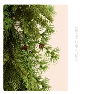 Detail of soft-touch Norfolk pine branches with natural pine cones for Christmas decor