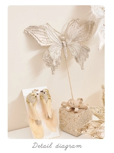 Detailed view of champagne gold butterfly and bird ornaments with feathers for Christmas decor