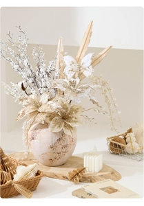 Champagne gold faux poinsettia with sequin butterflies in a vintage ceramic vase