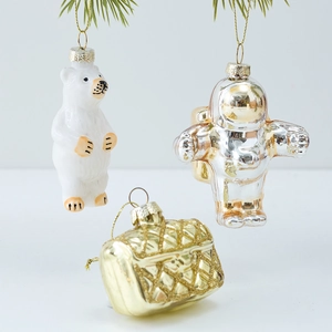 Christmas glass ornaments set with polar bear astronaut and quilted bag on pine branches