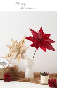 Detail of red and champagne artificial poinsettia flowers with festive sequins and beads