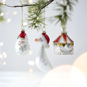 Three-piece painted glass Christmas ornaments featuring Santa, a goose, and circus tent
