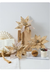 Close-up of champagne gold artificial poinsettia flowers with glitter and bead details