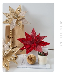 Close-up of artificial Christmas Poinsettia flowers with glittering sequins for holiday decor