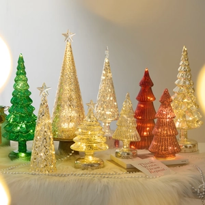 Champagne glass Christmas trees with LED lights and star toppers on plush decor
