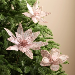 Pink glitter tulle artificial flowers for Christmas tree decoration in warm festive setting