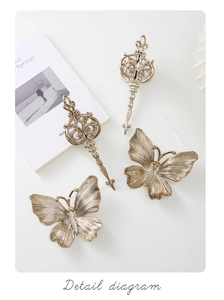Detail of vintage champagne gold butterfly and key ornaments with elegant textures