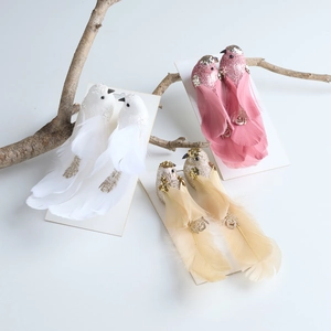 Sparkly glitter feather bird ornaments in white pink and gold for Christmas decor