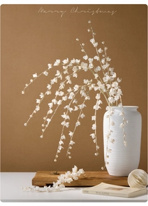 Macro detail of cream white faux pearl and sequin branch for Christmas floral decor