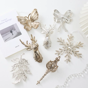 Elegant gold and silver Christmas ornaments set including reindeer and snowflake pendants