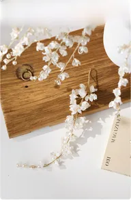 Detailed view of handmade pearlescent white flower picks with gold wire for holiday decor