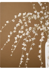 Detail of elegant handmade pearl and gold wire floral branch for Christmas decor