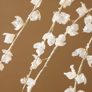 Elegant white pearl and gold glitter floral branch decoration for Christmas holiday decor