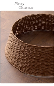 Detail of hand-woven dark brown rattan Christmas tree collar on warm wooden floor