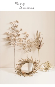 Close-up of champagne gold Christmas berry stems and pine needles with decorative balls