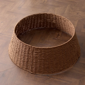 Dark brown woven Christmas tree collar with textured wicker design for base decoration