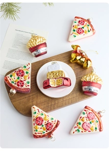 Creative glass Christmas ornaments featuring pizza, fries, and cake shapes with glitter